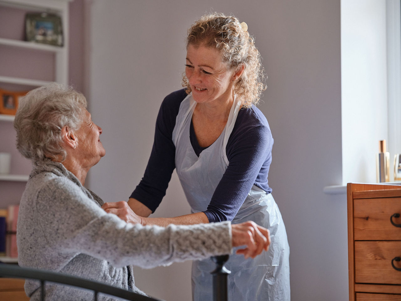 lady cares for old woman